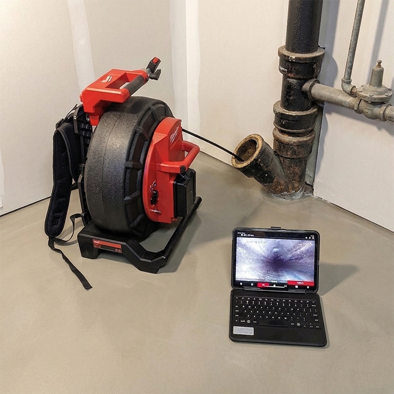 Milwaukee sewer camera inspection system with monitor showing live feed from inside a pipe